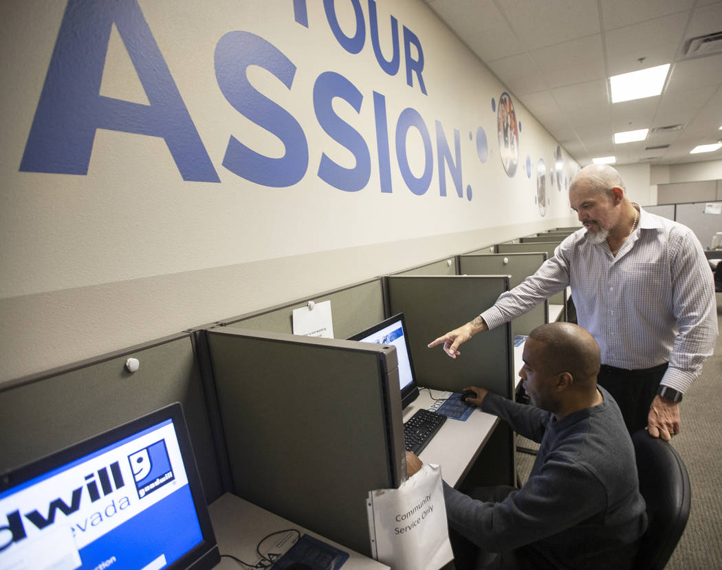 Marco Martinez, right, assists Donald Chapman at the Goodwill of Southern Nevada's career cente ...