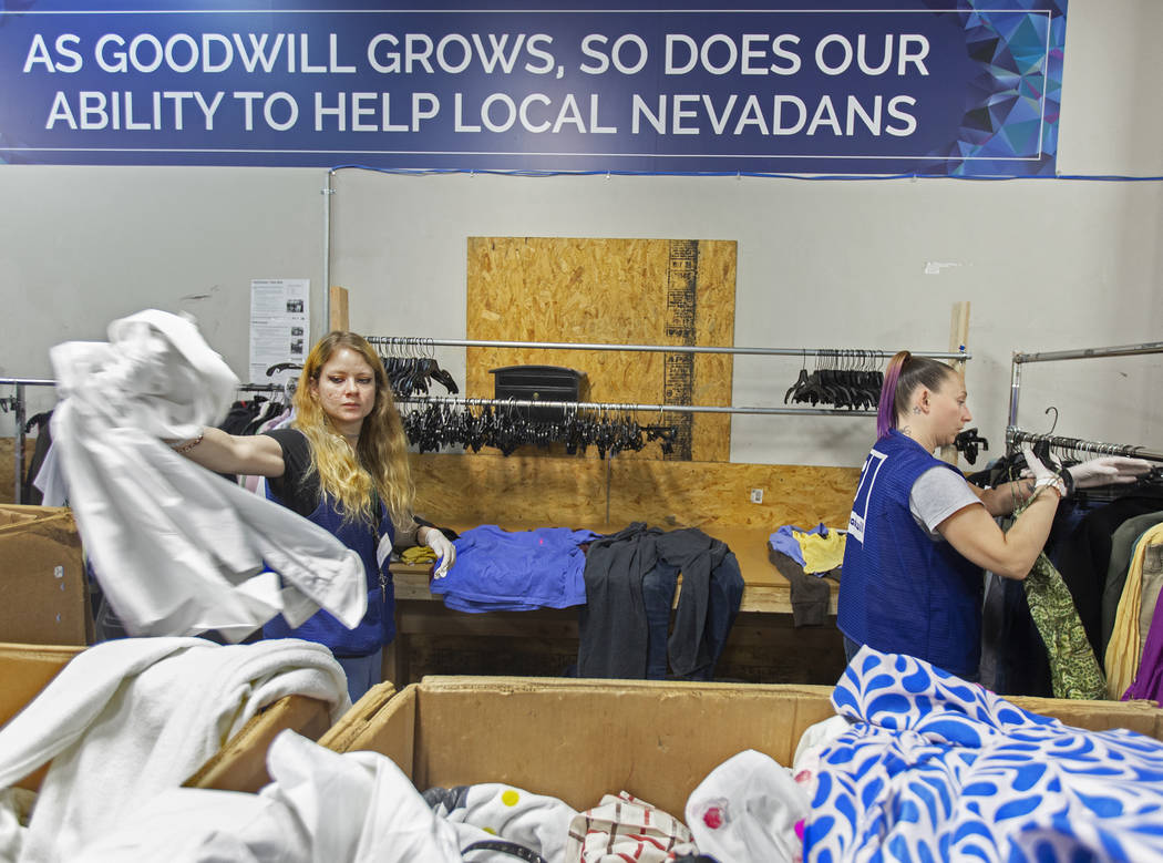 Shawnee Seay, left, and Katie Silber sort through donated clothing at Goodwill of Southern Neva ...