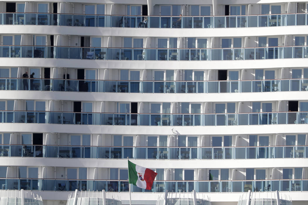 Passengers wait aboard the Costa Smeralda cruise ship, docked in the Civitavecchia port near Ro ...