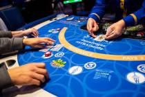 Blackjack dealer Amal Almisber, right, works the table as John and Shannon Welt, of Grants Pass ...