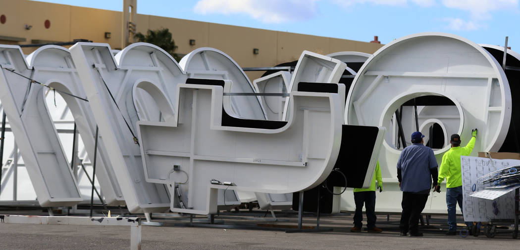 Workers store giant letters that's being built by Yesco, a customized business signs maker, for ...