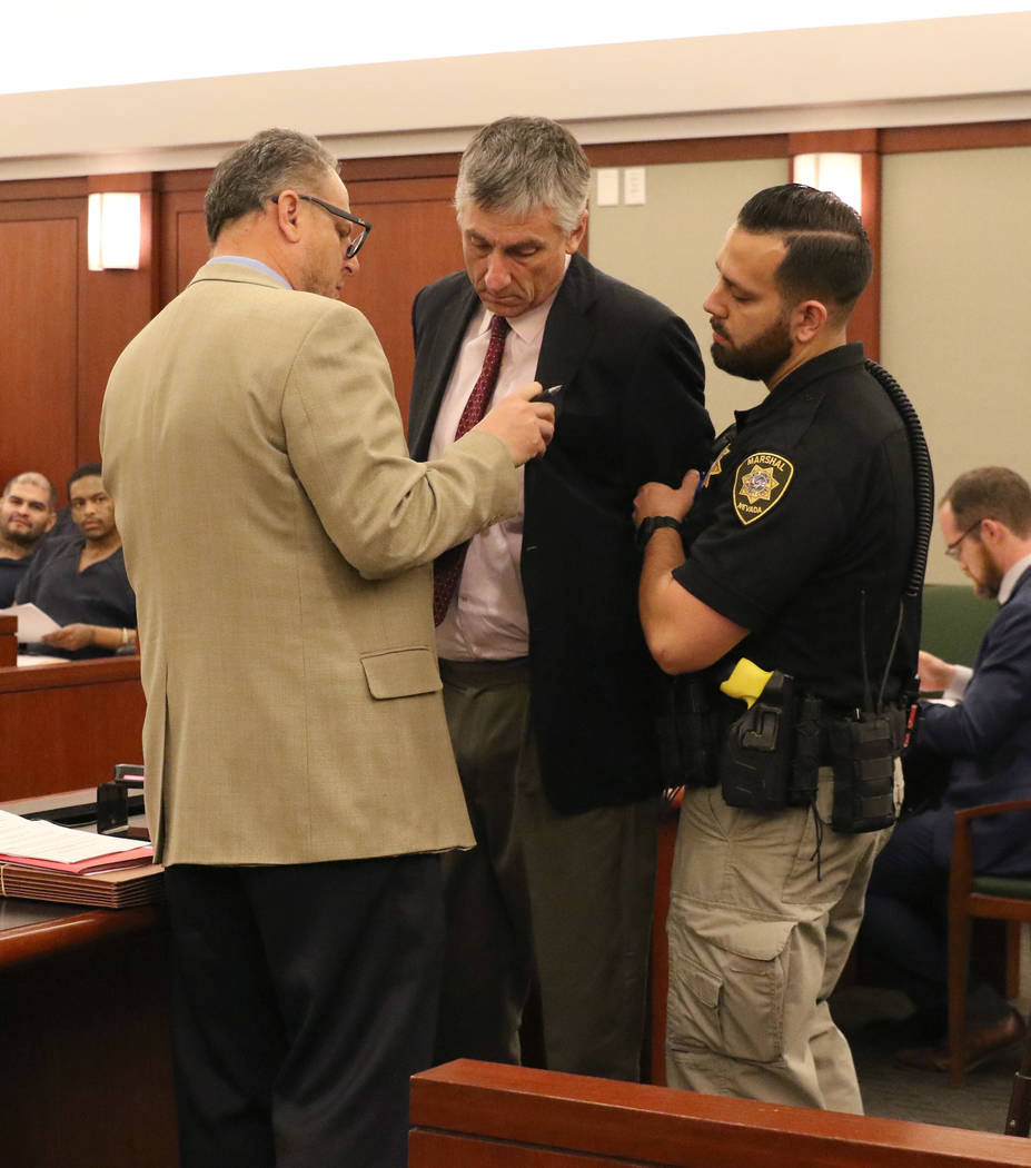 Former attorney William Gamage, center, talks to his attorney Bryan Cox, left, prior to being l ...