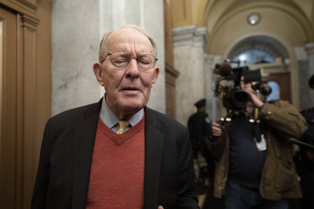 Republican Sen. Lamar Alexander of Tennessee, talks to reporters as he arrives at the Capitol f ...