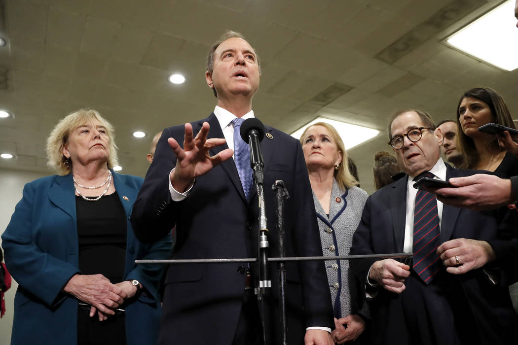 House impeachment manager Rep. Adam Schiff, D-Calif., second from left, speaks to reporters whi ...