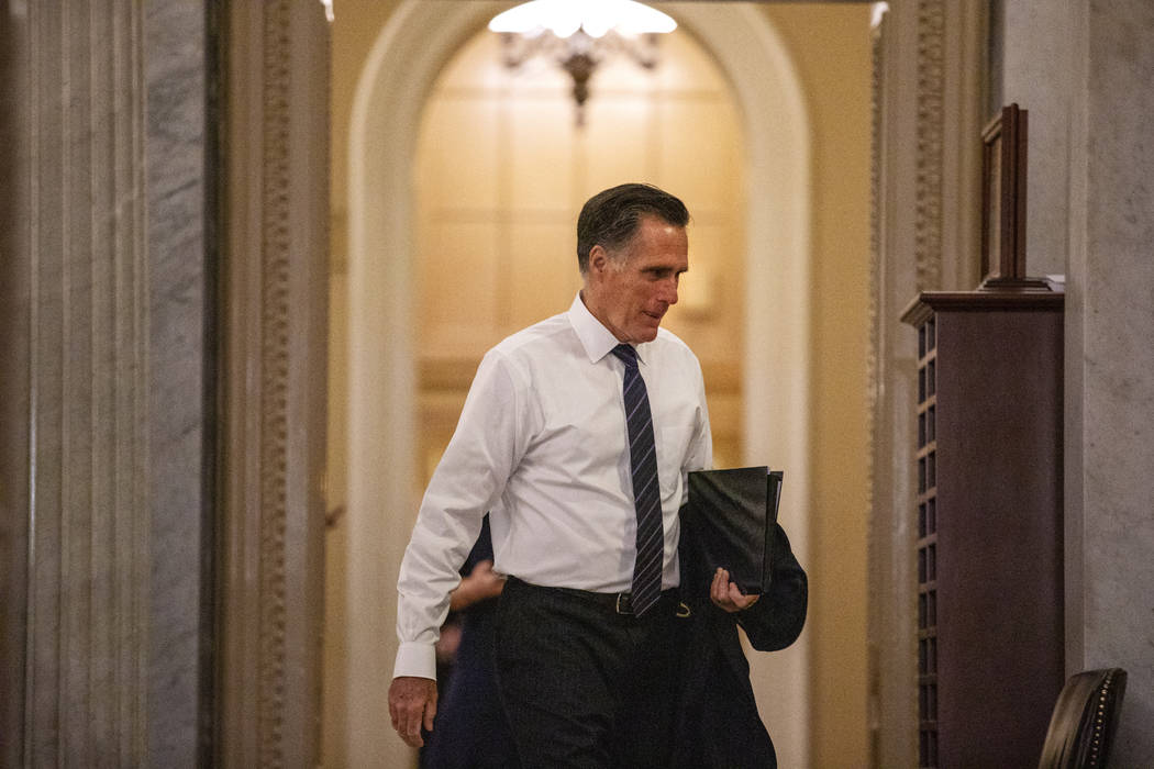 Sen. Mitt Romney, R-Utah, walks to the Senate chamber on Capitol Hill in Washington, Thursday, ...