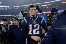 New England Patriots quarterback Tom Brady leaves the field after losing an NFL wild-card playo ...