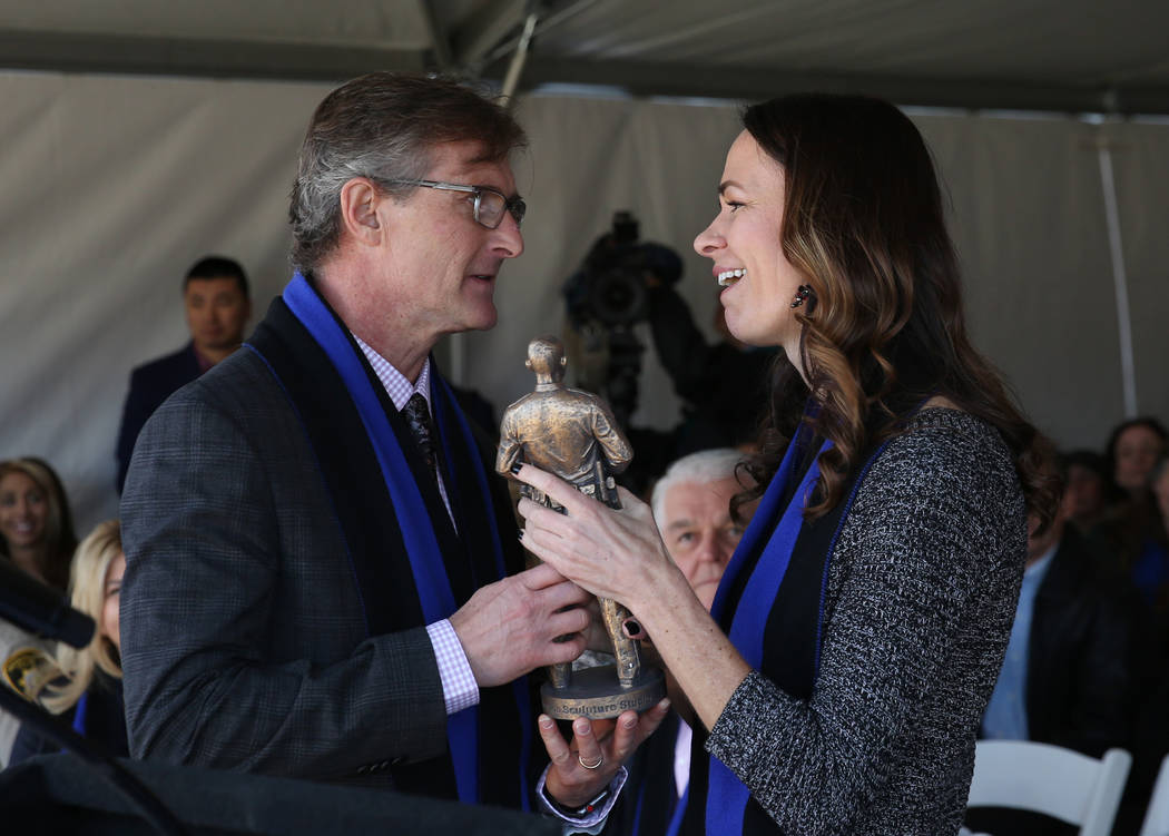 Officer Alyn Beck’s widow, Nicole Beck, receives a replica statue of a fallen Las Vegas ...