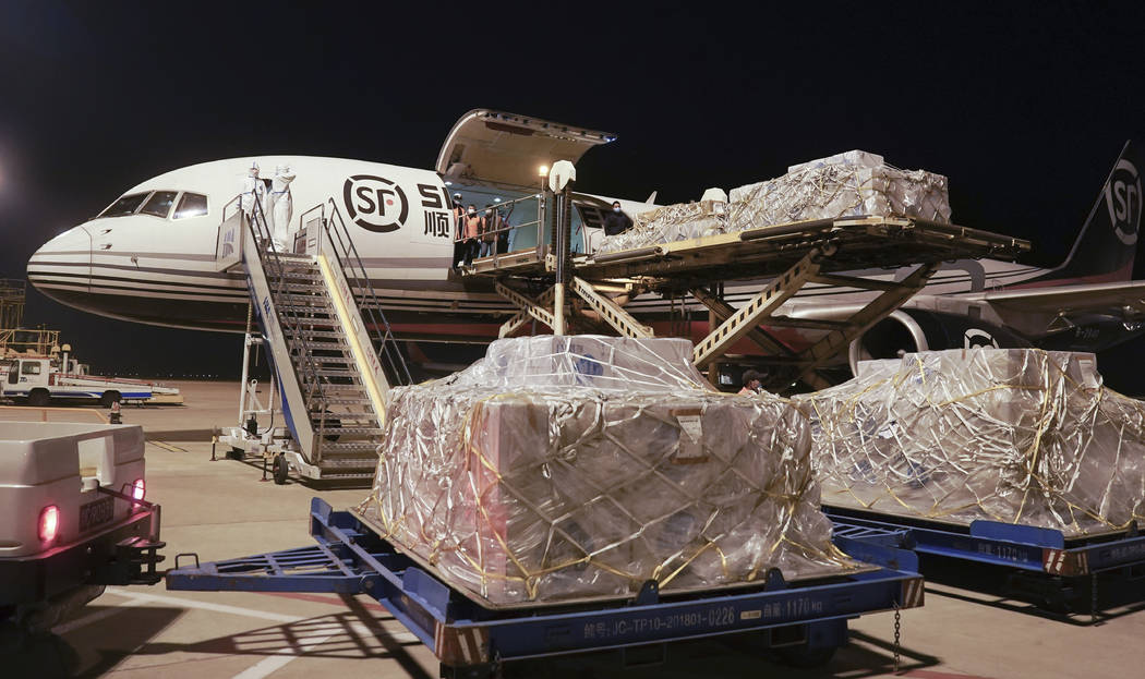 In this Jan. 30, 2020 photo released by China's Xinhua News Agency, workers unload a shipment o ...