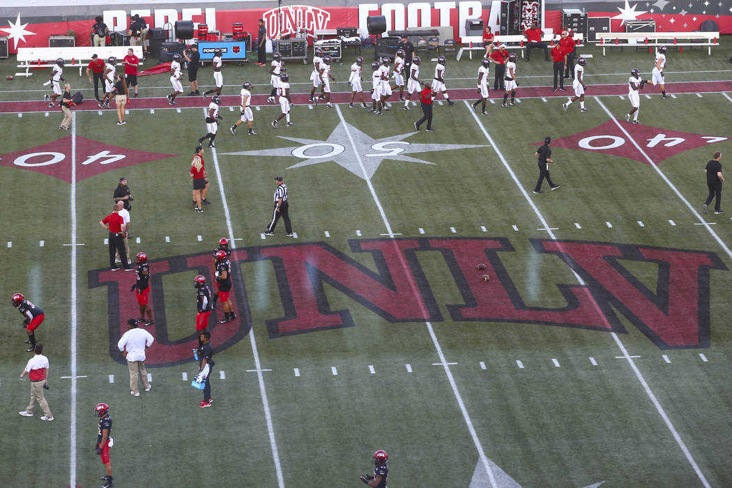 UNLV football players warm up before taking on Arkansas State in an NCAA football game at Sam B ...