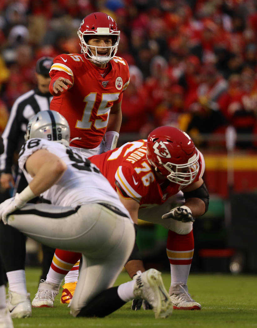 Kansas City Chiefs quarterback Patrick Mahomes (15) calls an audible at the line of scrimmage a ...