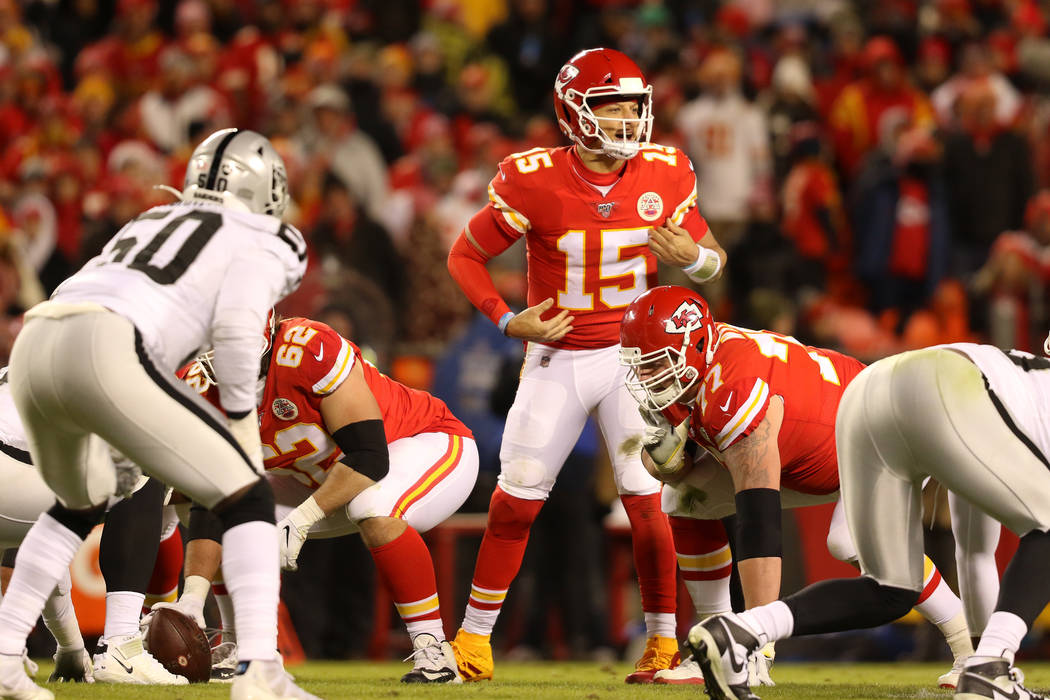 Kansas City Chiefs quarterback Patrick Mahomes (15) calls an audible at the line of scrimmage d ...