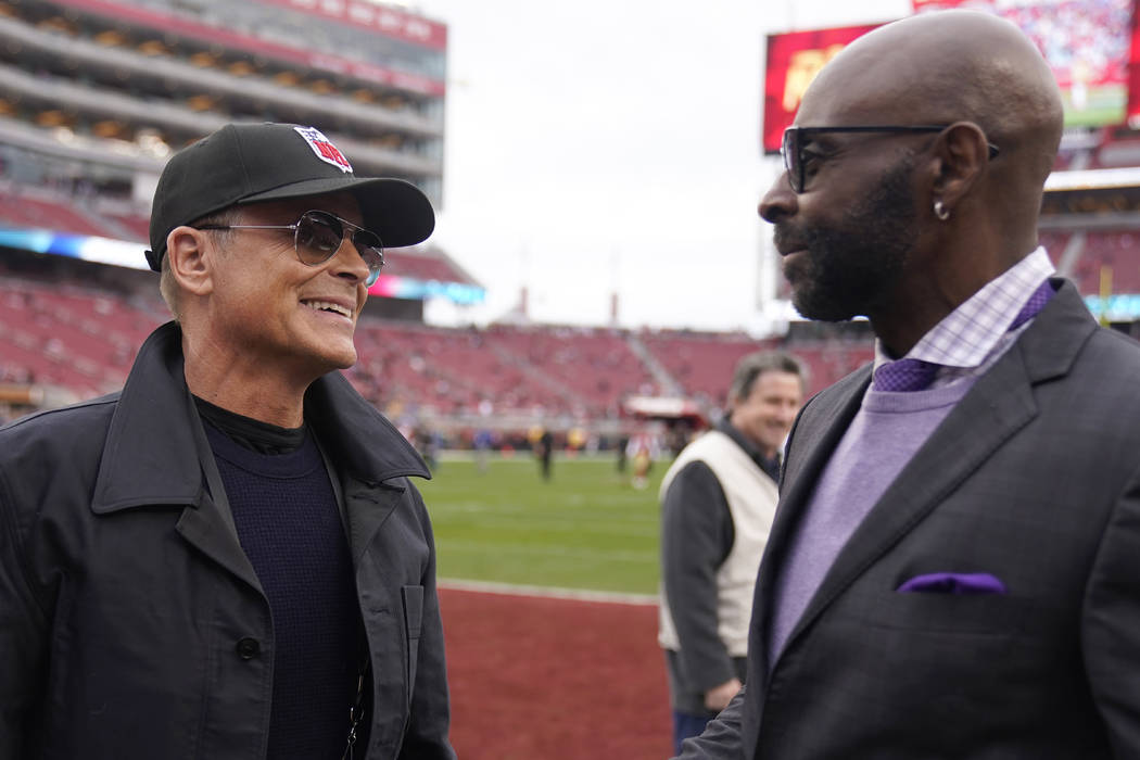 Actor Rob Lowe, left, talks with former wide receiver Jerry Rice before the NFL NFC Championshi ...