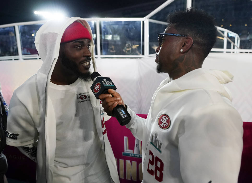 San Francisco 49ers' Tevin Coleman, left, is interviewed by teammate Jerick McKinnon during Ope ...