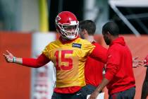 Kansas City Chiefs quarterback Patrick Mahomes (15) talks to a coach during practice on Friday, ...