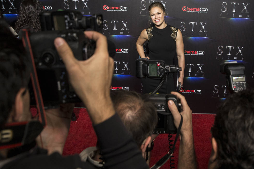 Ronda Rousey takes photos during the STXfilms red carpet event on the second night of CinemaCon ...