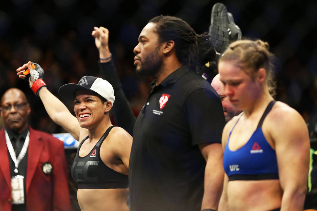 Amanda Nunes, left, celebrates after defeating Ronda Rousey by TKO in the first round during th ...