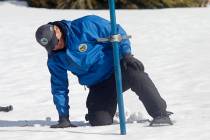 Sean de Guzman, chief of snow surveys for the California Department of Water Resources, checks ...