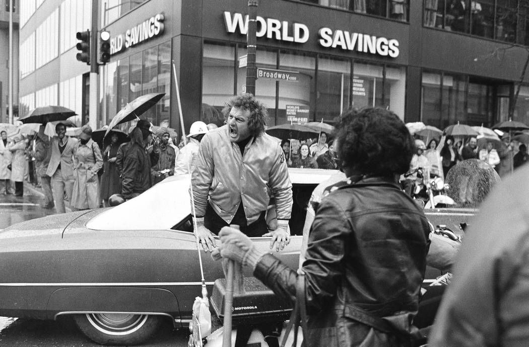 Big John Matuszak of the Super Bowl champion Raiders shouts at fans from his limousine during ...