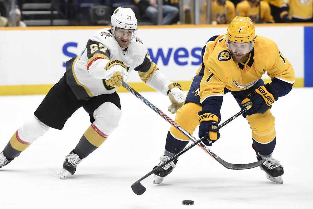 Nashville Predators defenseman Yannick Weber (7), of Switzerland, gets control of the puck in f ...