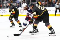 Golden Knights' William Carrier (28) battles for the puck against Columbus Blue Jackets' Nick F ...