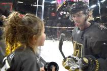 Vegas Golden Knights defenseman Jon Merrill sticks his tongue out at his daughter as he warms u ...
