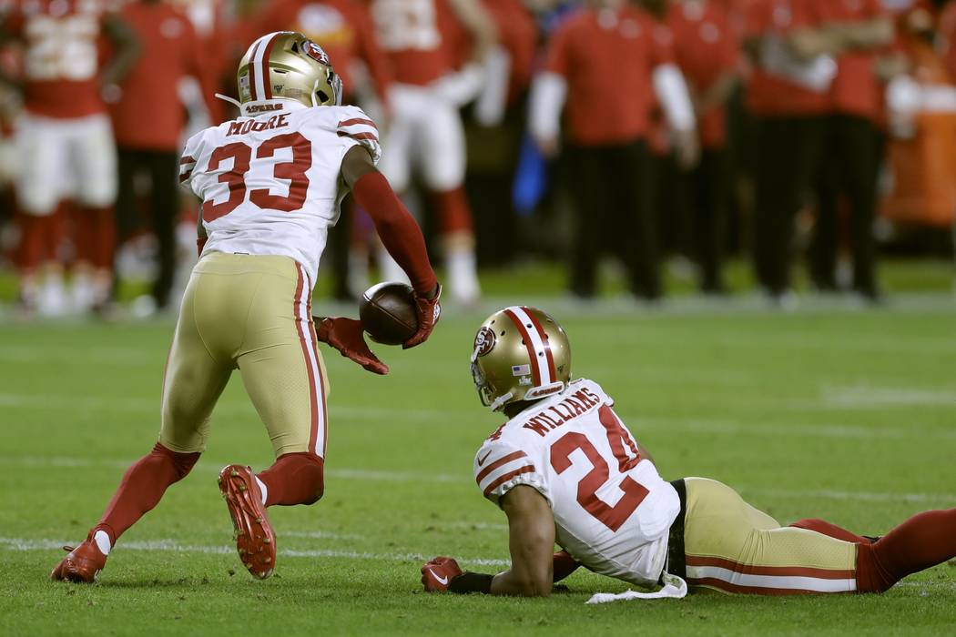 San Francisco 49ers' Tarvarius Moore, left, intercepts a pass against the Kansas City Chiefs du ...