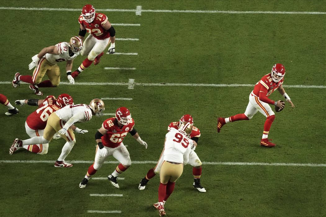 Kansas City Chiefs quarterback Patrick Mahomes (15) runs with the football, during the second h ...