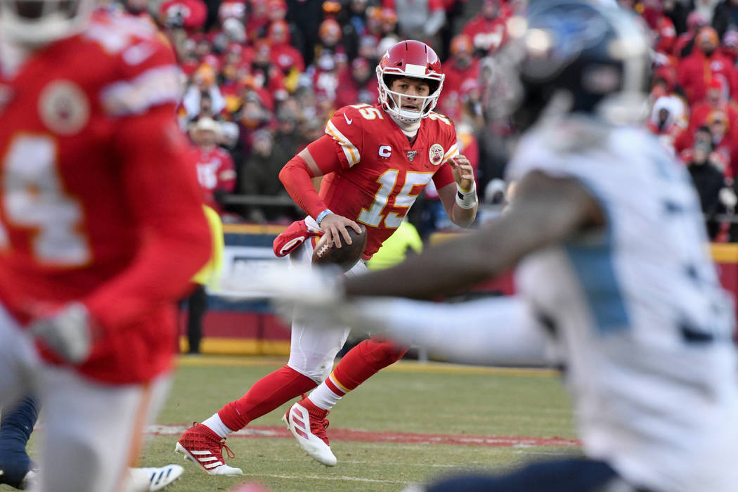 Kansas City Chiefs' Patrick Mahomes (15) runs for a touchdown during the first half of the NFL ...