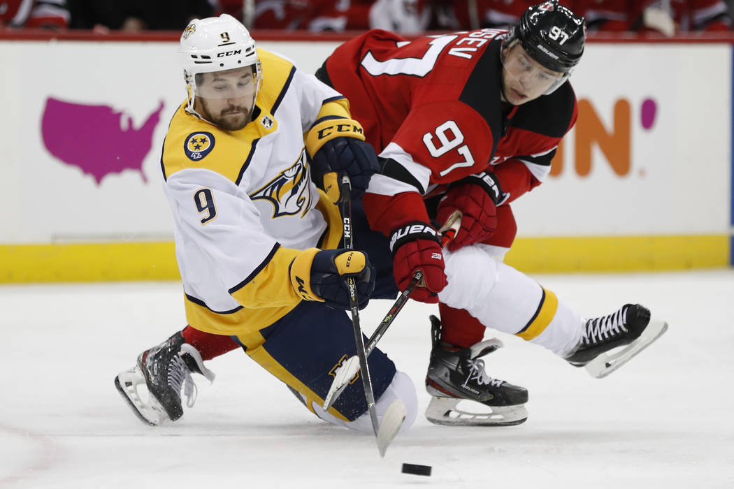 New Jersey Devils left wing Nikita Gusev (97), of Russia, and Nashville Predators left wing Fil ...