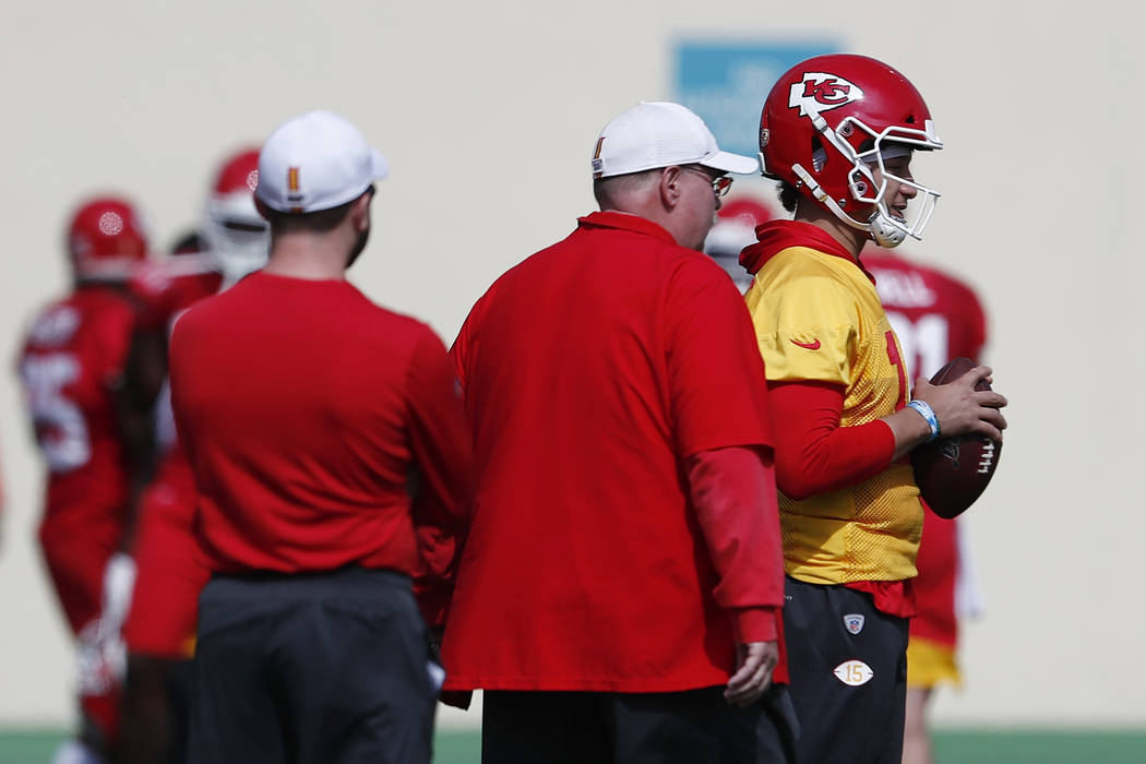 Kansas City Chiefs quarterback Patrick Mahomes (15) talks with head coach Andy Reid during prac ...