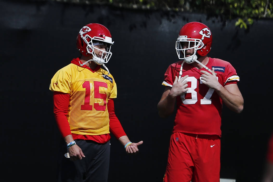 Kansas City Chiefs quarterback Patrick Mahomes (15) and tight end Travis Kelce (87) talk during ...