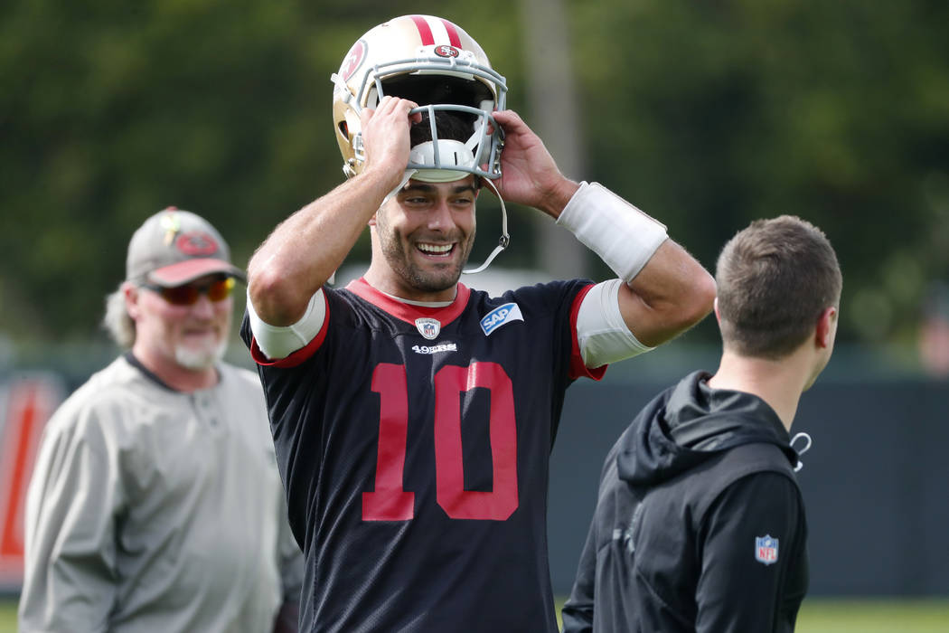 San Francisco 49ers quarterback Jimmy Garoppolo puts on his helmet during practice for the NFL ...
