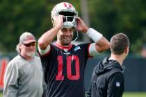 San Francisco 49ers quarterback Jimmy Garoppolo puts on his helmet during practice for the NFL ...