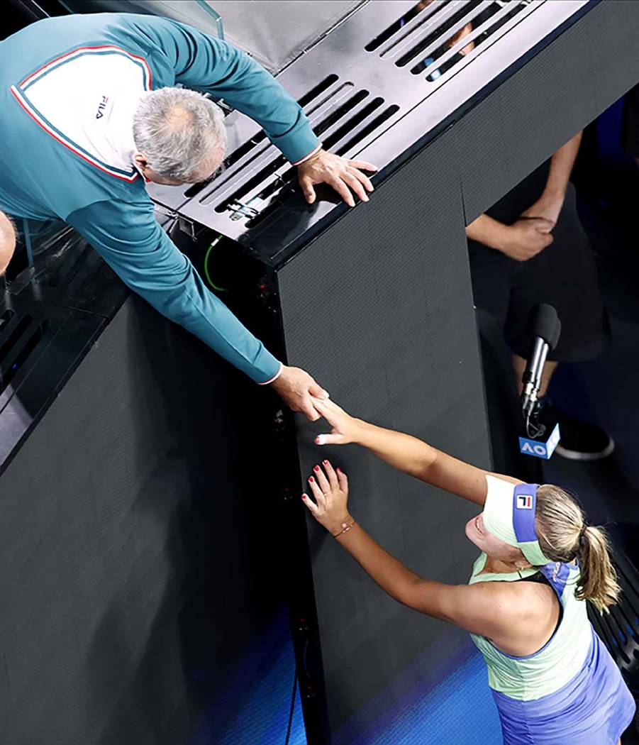Alex Kenin, left, congratulates his daughter Sofia Kenin of the U.S. after defeating Spain's Ga ...