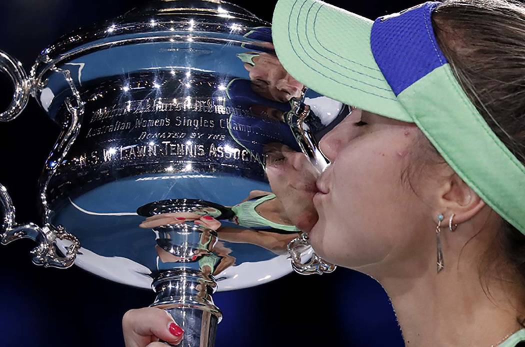 Sofia Kenin of the U.S. kisses the Daphne Akhurst Memorial Cup after defeating Spain's Garbine ...