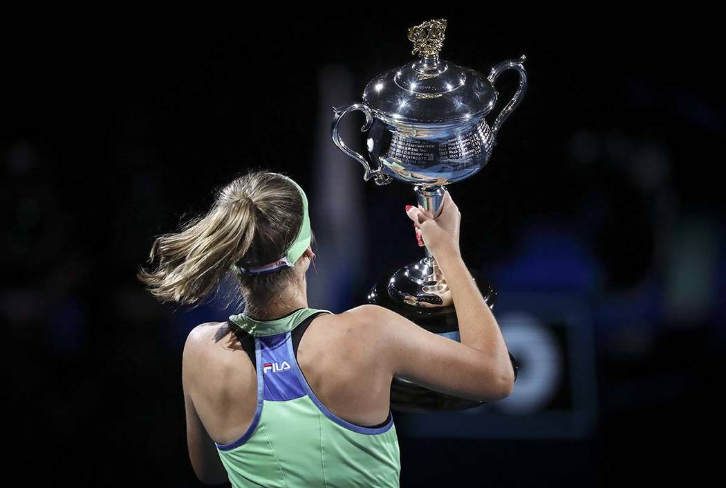 Sofia Kenin of the U.S. holds the Daphne Akhurst Memorial Cup aloft after defeating Spain's Gar ...