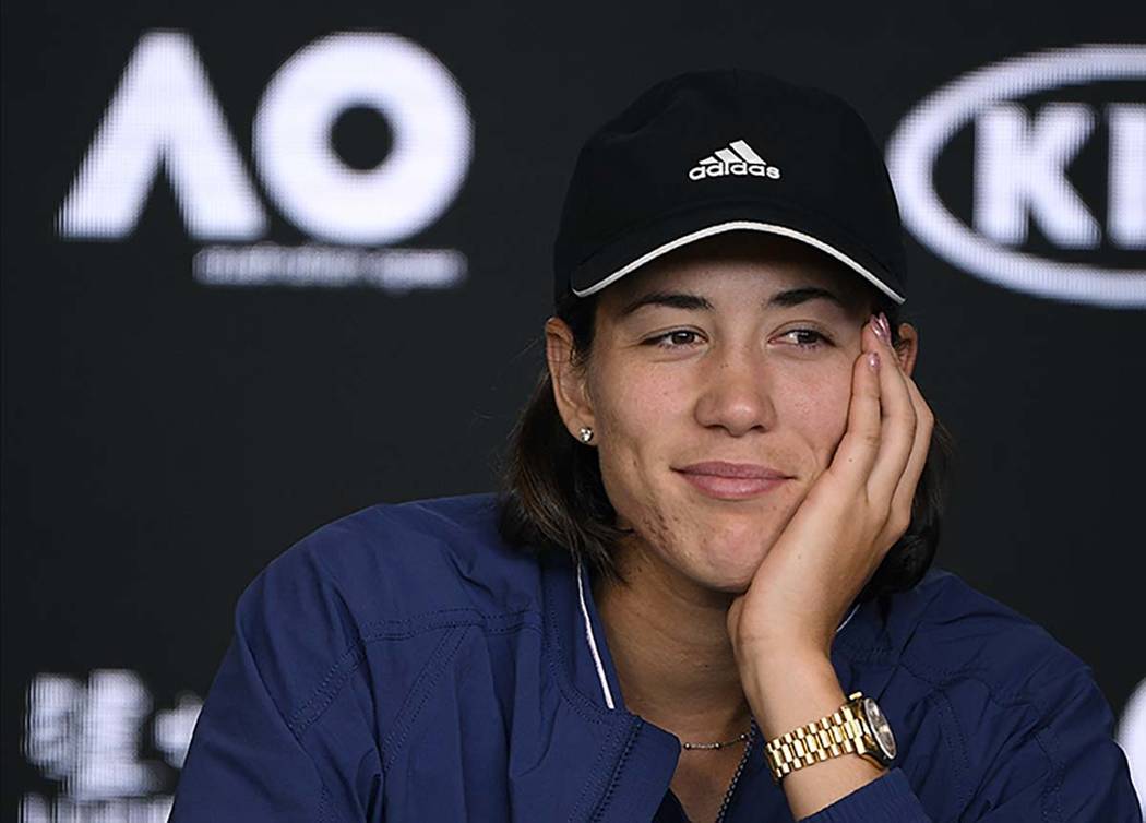 Spain's Garbine Muguruza answers questions at press conference following her loss to Sofia Keni ...