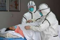 Medical workers in protective suits move a coronavirus patient into an isolation ward at the Se ...