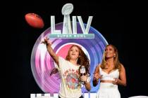 NFL Super Bowl 54 football game halftime performer Jennifer Lopez and Shakira throws a football ...