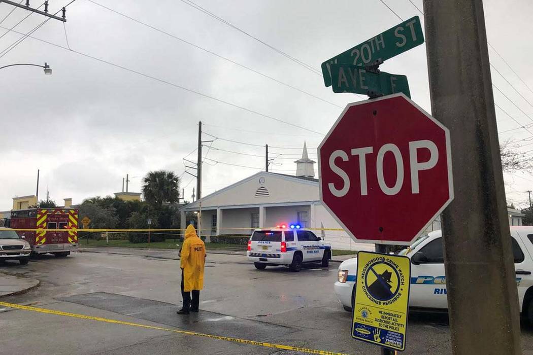 Law enforcement officials stand guard outside the Victory City Church in Riviera Beach, Fla., o ...