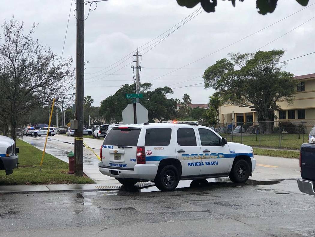 Law enforcement officials stand guard outside the Victory City Church in Riviera Beach, Fla., o ...