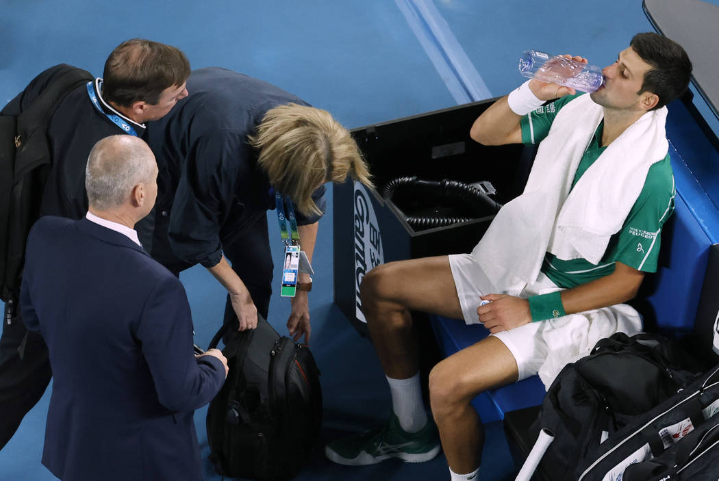 Serbia's Novak Djokovic is attended to by medical staff during his men's singles final against ...