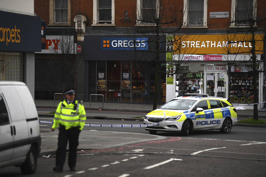 Police attend the scene after an incident in Streatham, London, Sunday Feb. 2, 2020. London pol ...