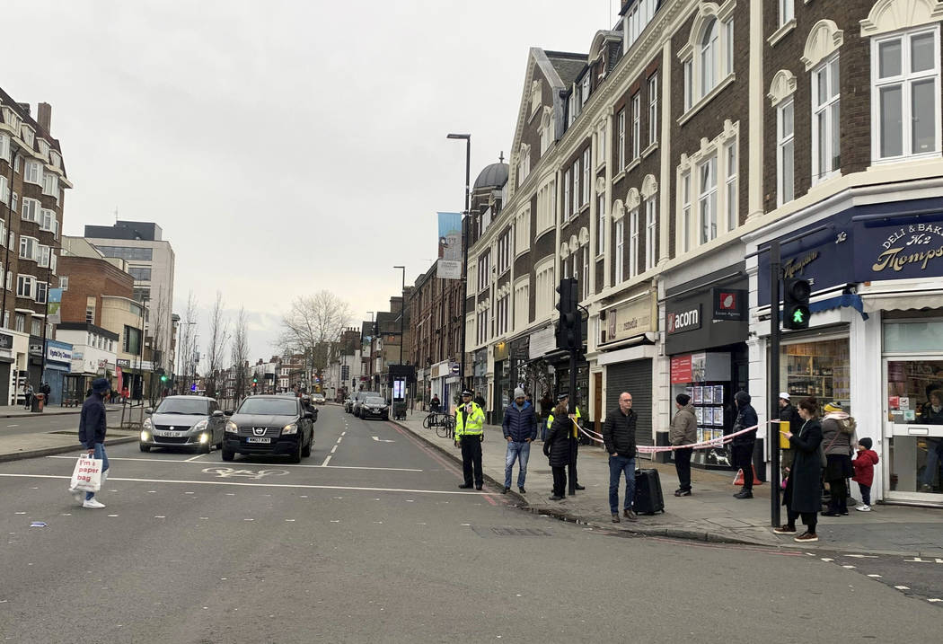 Police attend the scene after an incident in Streatham, London, Sunday Feb. 2, 2020. London pol ...