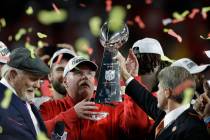 Kansas City Chiefs chairman Clark Hunt, right, hands the trophy to head coach Andy Reid after t ...