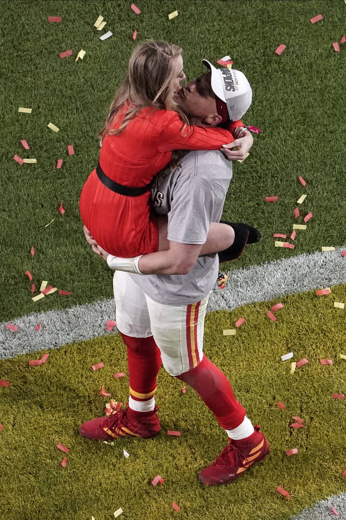 Kansas City Chiefs quarterback Patrick Mahomes (15) is kissed by his girlfriend Brittany Matthe ...