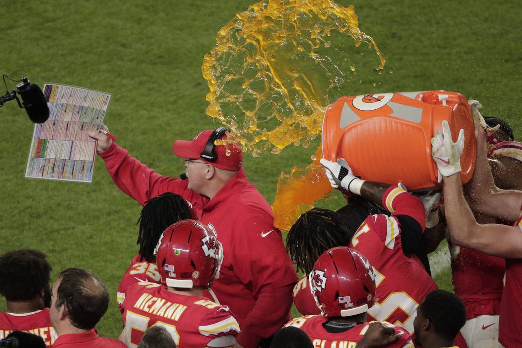 Kansas City Chiefs' players pour a cooler of Gatorade on head coach Andy Reid, during the secon ...