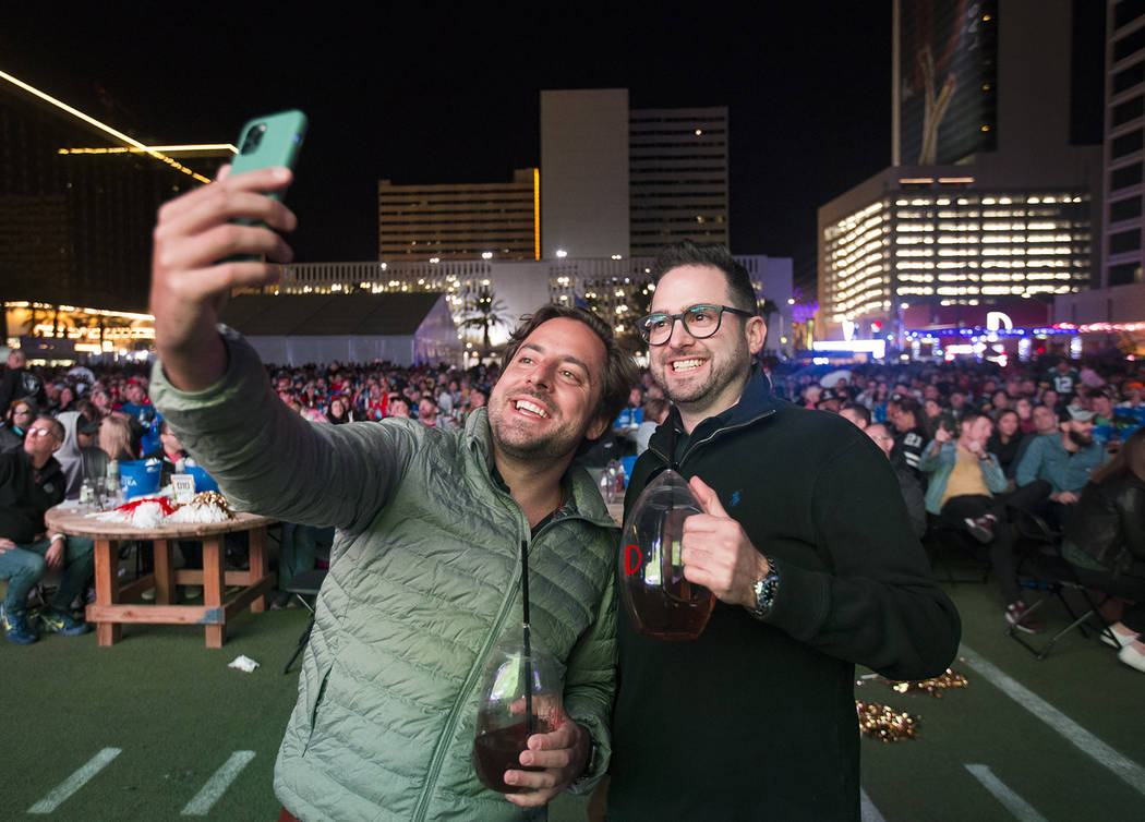 Paulo Penna, left, and Luigi Russo, right, both of Brazil, take a selfie at a watch party for t ...