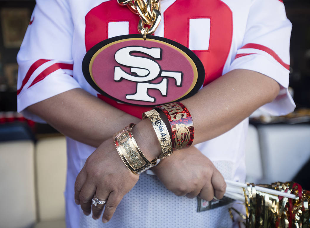 Sherry Lindsey, of Hawaii, shows off her 49ers accessories at a watch party for Super Bowl LIV ...