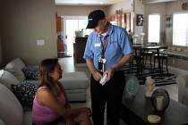 Red Cross volunteer Pat Moore shows Henderson resident Miroslayda Tito how to test her new 10-y ...